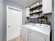 Laundry room with upper cabinets, shelving, washer, and dryer at 7979 Avenal Loop, New Port Richey, FL 34655