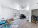 Bright living area featuring wood-look tile floors, a ceiling fan and sliding glass doors to the backyard at 7979 Avenal Loop, New Port Richey, FL 34655