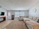 Comfortable living room with a large sectional couch, a window view and modern flooring at 7979 Avenal Loop, New Port Richey, FL 34655