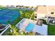 Aerial view of community pool and tennis courts surrounded by lush landscaping at 8211 Brent St # 836, Port Richey, FL 34668