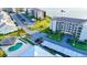 Enjoy community amenities in this aerial view of building exteriors, parking, pool, and lake at 8211 Brent St # 836, Port Richey, FL 34668