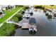 Aerial view highlighting a private boat dock along a tranquil canal, surrounded by lush greenery and peaceful waters at 8211 Brent St # 836, Port Richey, FL 34668