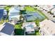 Aerial view showcases community amenities, including a pool and tennis courts, surrounded by lush landscaping at 8211 Brent St # 836, Port Richey, FL 34668