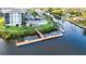 Aerial view showcasing the community's private docks and canals, complemented by a community pool and lush landscaping at 8211 Brent St # 836, Port Richey, FL 34668