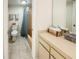Bathroom with a blue striped shower curtain and tile flooring, offering comfort and functionality at 8211 Brent St # 836, Port Richey, FL 34668
