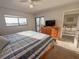 Comfortable bedroom with water views, a dresser and a private balcony at 8211 Brent St # 836, Port Richey, FL 34668