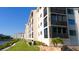 Well-maintained building exterior with enclosed balconies and landscaped grounds offers a comfortable living environment at 8211 Brent St # 836, Port Richey, FL 34668