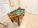 Well-lit game room featuring a foosball table, wood-look tile flooring, and white doors at 8211 Brent St # 836, Port Richey, FL 34668