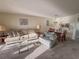 Inviting living room with plush sofa, patterned armchair, and access to dining area at 8211 Brent St # 836, Port Richey, FL 34668
