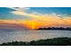 Waterfront view with a colorful sky featuring the sun setting over the ocean at 8211 Brent St # 836, Port Richey, FL 34668