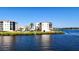 Waterfront condo buildings feature well-maintained landscaping, creating a peaceful residential setting at 8211 Brent St # 836, Port Richey, FL 34668
