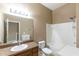 Neutral bathroom featuring a single sink vanity with granite top and a shower-tub combo with white tile surround at 8409 Blue Rock Dr, New Port Richey, FL 34653