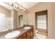 Bathroom with double sink vanity, large mirror, and lots of storage space with private toilet at 8409 Blue Rock Dr, New Port Richey, FL 34653