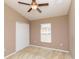 Cozy bedroom featuring neutral carpeting, a ceiling fan, a window for natural light, and a closet at 8409 Blue Rock Dr, New Port Richey, FL 34653