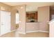 Bright entryway featuring tile flooring, arched doorway, and view into the kitchen at 8409 Blue Rock Dr, New Port Richey, FL 34653