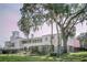 Stunning two-story home featuring stucco walls, a tile roof, and lush landscaping at 8409 Blue Rock Dr, New Port Richey, FL 34653