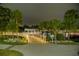 This serene night view captures a beautifully lit bridge amidst lush tropical landscaping at 8409 Blue Rock Dr, New Port Richey, FL 34653
