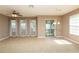 Bright living room with tile flooring, ceiling fan and sliding glass door that provides access to the backyard at 8409 Blue Rock Dr, New Port Richey, FL 34653