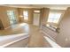 Open concept view of the living room, entry, and kitchen featuring neutral paint and tile flooring throughout at 8409 Blue Rock Dr, New Port Richey, FL 34653