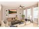 Comfortable living room with contemporary decor, a ceiling fan, and natural lighting at 8409 Blue Rock Dr, New Port Richey, FL 34653