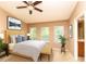 Comfortable main bedroom featuring vaulted ceiling, windows, and ensuite bathroom at 8409 Blue Rock Dr, New Port Richey, FL 34653