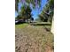 Backyard featuring lush greenery and potential for various outdoor activities at 8711 Jolly Roger Dr, Hudson, FL 34667