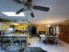 Open-concept with ceiling fan and kitchen view at 8711 Jolly Roger Dr, Hudson, FL 34667