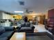 Spacious living room featuring tile floor and kitchen with large island at 8711 Jolly Roger Dr, Hudson, FL 34667