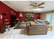 Living room featuring a stone fireplace, a ceiling fan and a pair of couches on a carpet at 8711 Jolly Roger Dr, Hudson, FL 34667