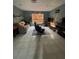 Open living room with tile flooring, comfortable seating and a window at 8711 Jolly Roger Dr, Hudson, FL 34667