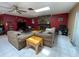 Spacious living room featuring a stone fireplace, a ceiling fan and a pair of couches on tile floors at 8711 Jolly Roger Dr, Hudson, FL 34667