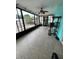 Sunroom featuring tiled floors, large sliding windows, and a ceiling fan at 8711 Jolly Roger Dr, Hudson, FL 34667