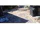 Paver patio with a stainless-steel grill, steps to an upper level, and natural surroundings at 8711 Jolly Roger Dr, Hudson, FL 34667