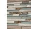 Close-up of decorative tile featuring seashells and natural tones at 8711 Jolly Roger Dr, Hudson, FL 34667