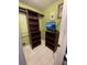 Spacious walk-in closet with custom shelving, a hanging rod and built-in storage at 8711 Jolly Roger Dr, Hudson, FL 34667