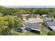 Aerial view of a well-kept home with a large backyard and mature trees at 8807 Village Mill Row, Hudson, FL 34667