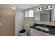 Bathroom featuring a granite countertop vanity, updated fixtures and neutral ceramic tile at 8807 Village Mill Row, Hudson, FL 34667