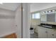 Well-lit bathroom featuring granite countertops, ceramic tile flooring, and ample storage space at 8807 Village Mill Row, Hudson, FL 34667