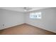 Comfortable bedroom with tile flooring, natural light, and a ceiling fan at 8807 Village Mill Row, Hudson, FL 34667
