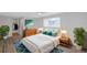 Cozy bedroom with stylish decor, a comfortable bed, and ample natural light, creating a relaxing retreat at 8807 Village Mill Row, Hudson, FL 34667