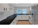 Modern kitchen featuring dark countertops, stainless appliances, and tile floors at 8807 Village Mill Row, Hudson, FL 34667