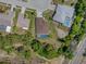 Aerial view of a well-maintained single-Gathering home with a private screened-in pool and lush backyard landscaping at 9019 Flagstick Ln, Hudson, FL 34667