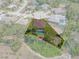 Aerial view showcasing the property's boundaries, pool, and surrounding neighborhood in a tree-lined community at 9019 Flagstick Ln, Hudson, FL 34667