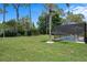 Private backyard with a screened-in pool, surrounded by lush greenery for a tranquil setting at 9019 Flagstick Ln, Hudson, FL 34667