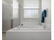 Relaxing bathroom showcasing a soaking tub, a separate shower, and a bright window with blinds at 9019 Flagstick Ln, Hudson, FL 34667