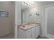 Bathroom with granite countertop vanity, large mirror, and coastal décor at 9019 Flagstick Ln, Hudson, FL 34667