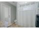 Bathroom featuring tile flooring, granite counters, a separate shower, and a convenient door at 9019 Flagstick Ln, Hudson, FL 34667