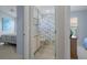 Bathroom featuring a tiled floor, a toilet, and a partial view of the connected bedroom at 9019 Flagstick Ln, Hudson, FL 34667