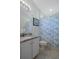 Well lit bathroom featuring granite countertop, white cabinets and ocean-themed shower curtain at 9019 Flagstick Ln, Hudson, FL 34667