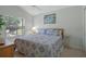 Serene bedroom with a large window, ceiling fan, and comfortable furnishings at 9019 Flagstick Ln, Hudson, FL 34667